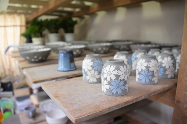 棚に並ぶ焼き入れ前の陶芸作品の写真