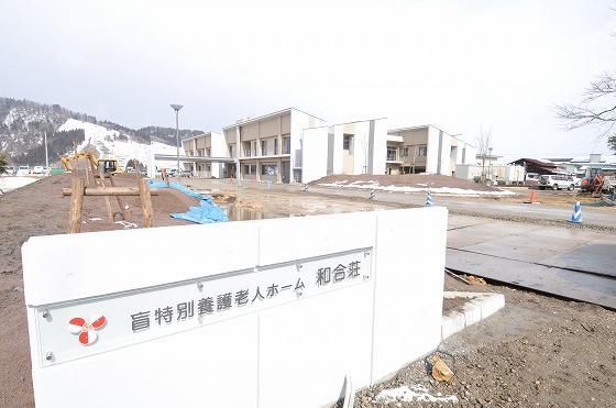 入口看板と施設外観の写真